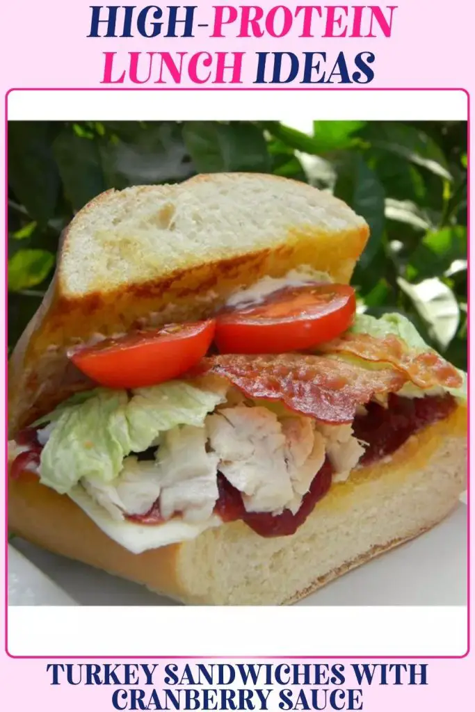 Turkey sandwich with cranberry, bacon, and cheese stacked in bread, delivering a tasty high protein lunch recipe that fuels muscles while supporting weight loss goals.