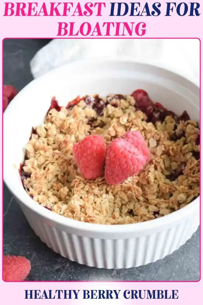 Healthy Berry Crumble dish displays strawberries and raspberries under a crisp oat topping. A bloating breakfast that’s warm, cozy, and easy on digestion with fiber and sweetness.